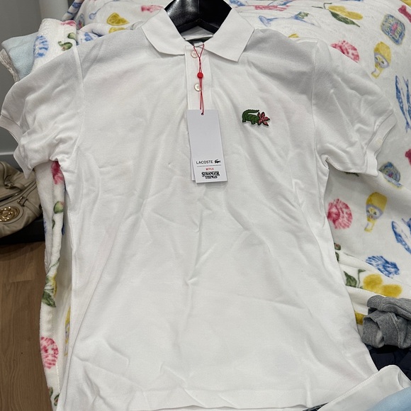 Lacoste Tops - Lacoste White Polo with Stranger Things Logo… never worn! Tags on!
